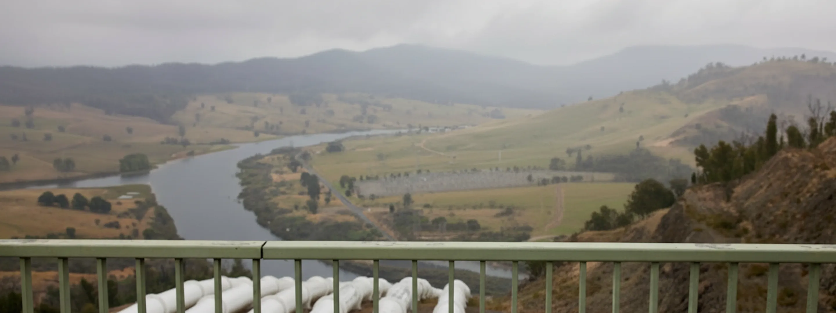 Snowy hydro scheme with worker in the foreground